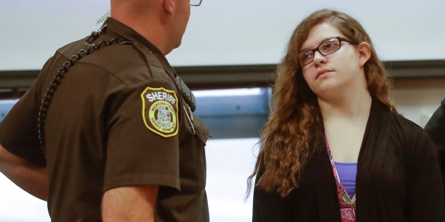 Anissa Weier talks to a sheriff's deputy during a pause in jury selection.