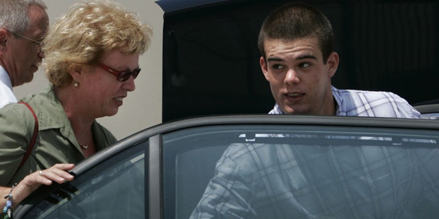 Sept. 3, 2005: Dutch teen Joran van der Sloot, 18, enters his family's car as his mother Anita closes the door after he was conditionally released from the KAI jail in San Nicolas, Aruba.