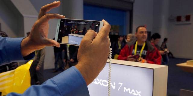 File photo: A man takes a photo with an Axon 7 Max smartphone with 3D camera at the ZTE booth during the 2017 CES in Las Vegas, Nevada January 6, 2017. (REUTERS/Steve Marcus)