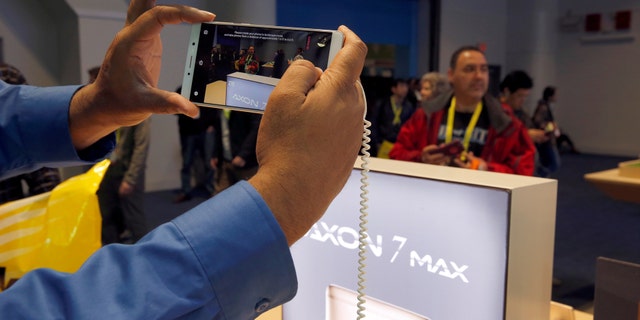 File photo: A man takes a photo with an Axon 7 Max smartphone with 3D camera at the ZTE booth during the 2017 CES in Las Vegas, Nevada January 6, 2017. (REUTERS/Steve Marcus)