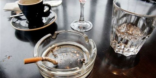 FILE - In this Thursday, Dec. 27, 2007 file photo, a cigarette burns out in an ashtray after lunch at a restaurant in Paris. According to a report released on Wednesday, Feb. 4, 2015, for the first time, lung cancer has passed breast cancer as the leading cause of cancer deaths for women in rich countries, according to the American Cancer Society based on new numbers from the International Agency for Research on Cancer. (AP Photo/Francois Mori)