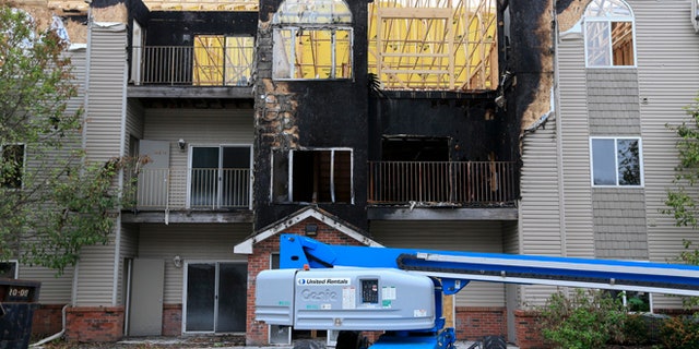 In this Sept. 14, 2016, photo, restoration work is performed at a Bellevue, Neb., apartment complex which was hit twice by fire.