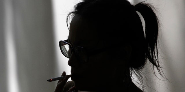FILE: 2012: A woman smokes a cigarette in Los Angeles, Calif.