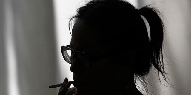 FILE: 2012: A woman smokes a cigarette in Los Angeles, Calif.