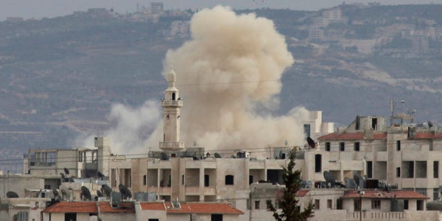March 11: Smoke rises as Idlib city is shelled by government forces. Activists said at least four people were killed in Idlib on Sunday after troops and tanks moved in a day earlier.