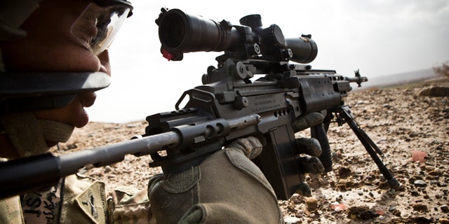 Feb. 3, 2013: A U.S. Army sniper with Charlie Company, 36th Infantry Regiment, 1st Armored Division looks down the scope of his rifle during a mission near Command Outpost Pa'in Kalay in Maiwand District, Kandahar Province.