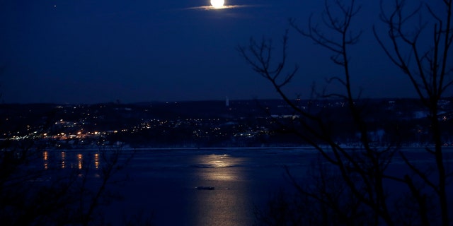 The full "Snow" moon rises above the Hudson River and the town of Irvington in Westchester County New York as seen from the west side of the Hudson in the town of Orangeburg in Rockland County, New York February 3, 2015. "Snow" moon is a traditional name for the full moon that occurs in the winter month of February in North America. (REUTERS/Mike Segar)