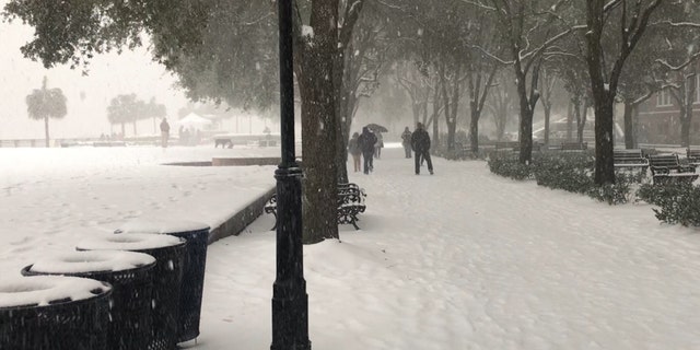 Snow covers the Charleston Waterfront Park.