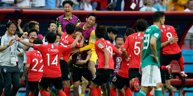 South Korea players celebrate after their teammate Kim Young-gwon scored their side's first goal during the group F match between South Korea and Germany.