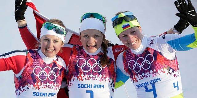 Feb. 11, 2014: Norway's gold medal winner Maiken Caspersen Falla is flanked by silver medal winner Ingvild Flugstad Oestberg from Norway, left, and Slovenia's bronze medal winner Vesna Fabjan after the women's cross-country sprint the 2014 Winter Olympics in Krasnaya Polyana, Russia.