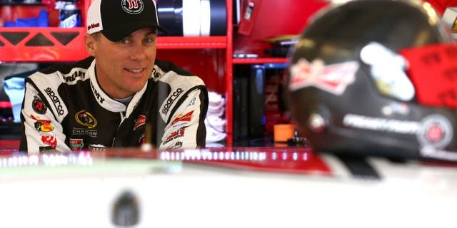 JOLIET, IL - SEPTEMBER 18: Kevin Harvick, driver of the #4 Jimmy John's / Budweiser Chevrolet, stands in the garage area during practice for the NASCAR Sprint Cup Series myAFibRisk.com 400 at Chicagoland Speedway on September 18, 2015 in Joliet, Illinois. (Photo by Sarah Crabill/NASCAR via Getty Images)