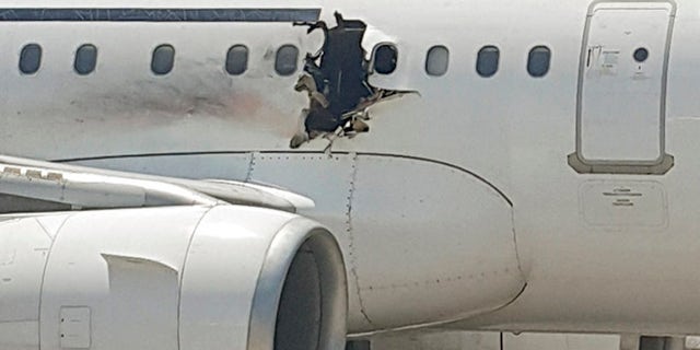 FILE: A hole is photographed in a plane operated by Daallo Airlines as it sits on the runway of the airport in Mogadishu, Somalia. Abdullahi Abdisalam Borleh boarded the plane on Feb. 2 with a bomb which exploded at 11,000 feet.