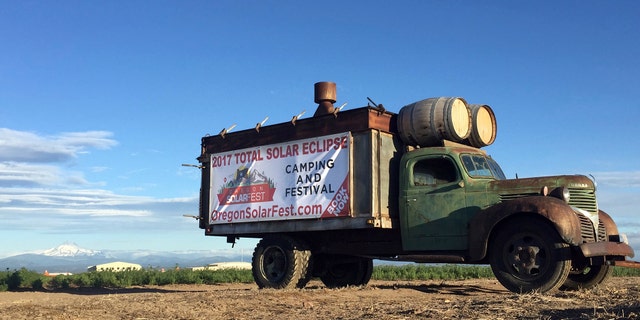 FILE - In this June 13, 2017, file photo, an advertisement for a central Oregon festival built around the Aug. 21 total solar eclipse sits alongside a busy road leading into Madras, Ore. Traffic is already a headache in central Oregon as thousands of people arrive before Monday's total solar eclipse. (AP Photo/Gillian Flaccus, File)