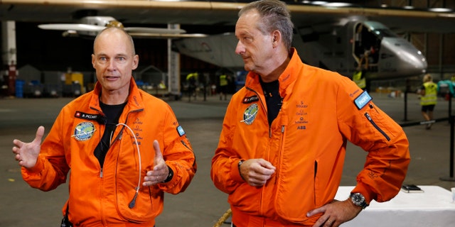 Solar Impulse 2 pilots Bertrand Piccard, left, and Andre Borschberg speak to the media in front of the solar plane from the Kalaeloa Airport, Thursday, April 21, 2016, in Kapolei, Hawaii. The Solar Impulse team landed in the islands in July after a record-breaking flight from Japan. (AP Photo/Marco Garcia)