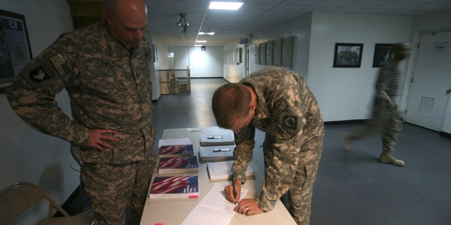 Oct. 15, 2008: U.S Ist Lt Nath Perry of Combained Joint Task Force-101 filling out voter absentee ballot at a US military base in Bagram north of Kabul, Afghanistan.