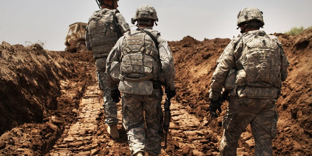 ISKANDARIYA, IRAQ - JULY 19: U.S. soldiers with the 3rd Armored Cavalry Regiment patrol a new ditch they have dug to protect the base from attack on July 19, 2011 in Iskandariya, Babil Province Iraq. As the deadline for the departure of the remaining American forces in Iraq approaches, Iraqi politicians have agreed to meet in two weeks time in order to give a final decision about extending the U.S. troops' presence beyond the end of the 2011 deadline. Violence against foreign troops has recently picked-up with June being the worst month in combat-related deaths for the military in Iraq in more than two years. Currently about 46,000 U.S. soldiers remain in Iraq. (Photo by Spencer Platt/Getty Images)