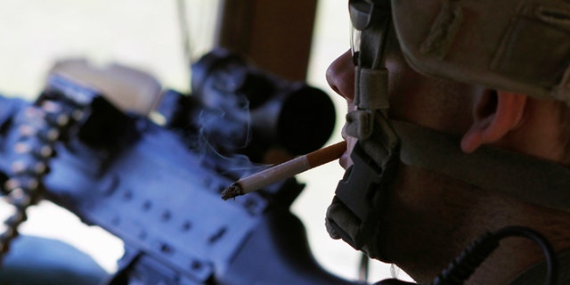 Sep. 26, 2011 U.S. soldier smokes a cigarette while manning his post in a bunker in eastern Afghanistan.