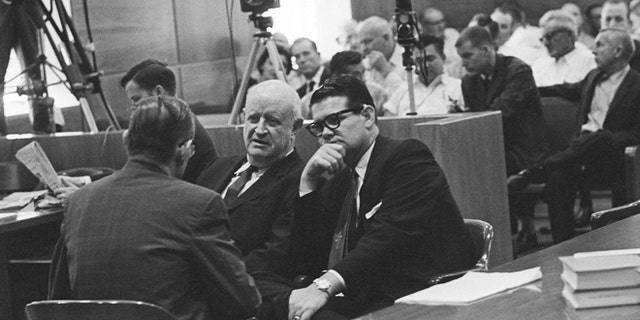 Sept. 25, 1962: In this file photo, Billie Sol Estes, right, confers with his attorneys, John Cofer, center, and John Dennison during recess in trial in Tyler, Texas