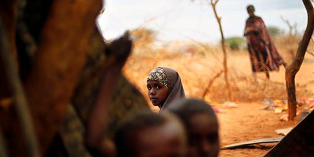 Tuesday: A Somali refugee sits at an outdoor madrasa at the Ifo camp outside Dadaab, Eastern Kenya.
