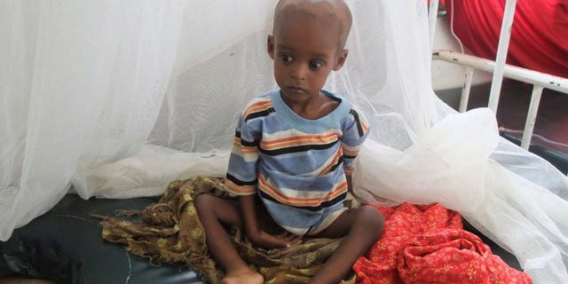 Aug. 1: A malnourished child from southern Somalia sits on a bed at Banadir hospital in Mogadishu.
