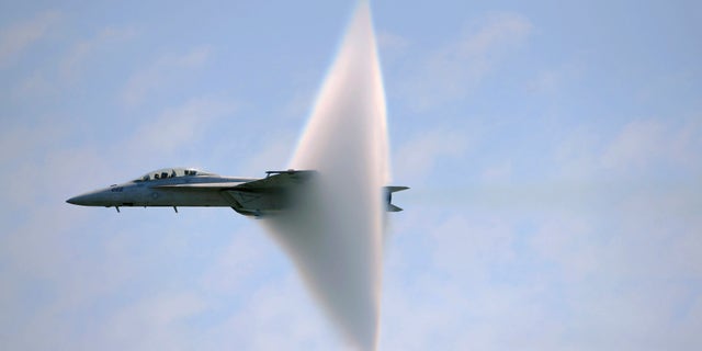 A ring of water vapour is created around pilot Lt. Justin Halligan (L) and Lt. Michael Witt (R) as they fly their F/A-18F Super Hornet airplane within 200mph of breaking the sound barrier while performing at New York Air Show at Jones Beach in Wantagh, New York, May 23, 2009