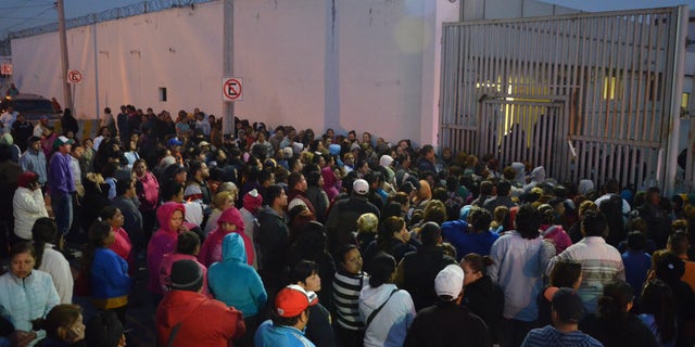 Feb. 11, 2016: Relatives of inmates stand outside the Topo Chico prison, where a riot broke out overnight in Monterrey, Mexico. (AP)