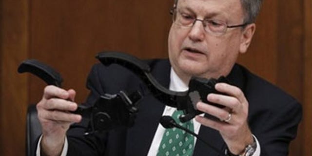 Feb. 24: House Oversight and Government Reform Committee member Rep. Mark Souder, R-Ind., holds two Toyota accelerator pedals while asking a question of Toyota President and Chief Executive Officer Akio Toyoda, on Capitol Hill in Washington. (AP Photo)