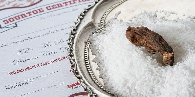 The bar at the hotel keeps the dismembered toes in rock salt in order to dry them out.