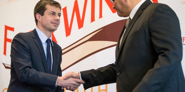 South Bend Mayor Pete Buttigieg, left, shakes hands with John Warren, chairman of the Pokagon Band, during news conference, Wednesday, Dec. 7, 2016, in South Bend, Ind.