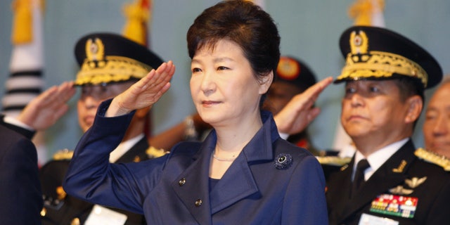South Korean President Park Geun-hye, center, gives a salute during the 67th Armed Forces Day at Gyeryongdae, South Korea's main compound in Gyeryong City, South Korea, Oct. 1, 2015. (Kim Hee-chul/Pool Photo via AP)