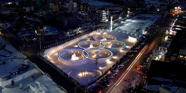 An ice sculpture of the Olympic rings is illuminated near the venue for the opening and closing ceremony of the 2018 Winter Olympics, in Pyeongchang, South Korea, Feb. 10, 2017.