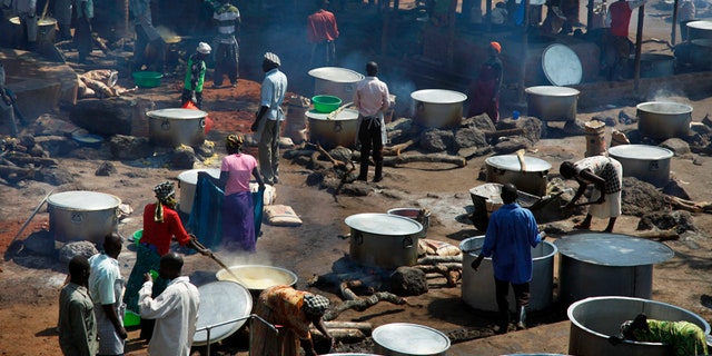 Aug. 29, 2016: Refugees prepare food in a transit center for South Sudanese refugees in the remote northwestern district of Adjumani, near the border with South Sudan, in Uganda.