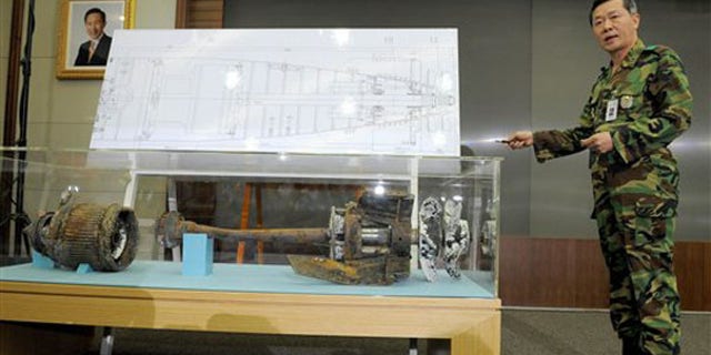 A South Korean military officer shows torpedo parts salvaged from the Yellow Sea during a press conference in Seoul May 20. (AP Photo)