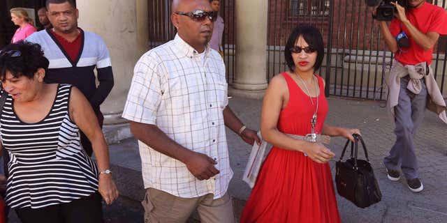 Feb. 27, 2015: Celeste Nurse, right, the mother of a girl that was kidnapped as a baby 17 years ago, leaves the court after attending the appearance of a woman suspected of the kidnapping in Cape Town, South Africa.
