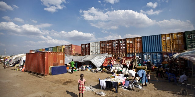 Dec. 29, 2013: In this file photo, a displaced child stands in front of the makeshift tents where she and others live next to shipping containers at a United Nations compound which has become home to thousands of people displaced by the recent fighting, in the capital Juba, South Sudan.
