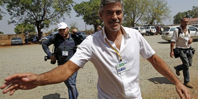 George Clooney walks in front of St. Teresa's Cathedral during the independence referendum in Juba, South Sudan Jan. 9, 2011.