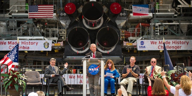 NASA Administrator Charles Bolden announces where four space shuttle orbiters will be permanently displayed at the conclusion of the Space Shuttle Program during an event held at one of the Orbiter Processing Facilities, Tuesday, April 12, 2011, at Kennedy Space Center in Cape Canaveral, Fla. The four orbiters, Enterprise, which currently is on display at the Smithsonian's Steven F. Udvar-Hazy Center near Washington Dulles International Airport, will move to the Intrepid Sea, Air & Space Museum in New York, Discovery will move to Udvar-Hazy, Endeavour will be displayed at the California Science Center in Los Angeles and Atlantis, in background, will be displayed at the Kennedy Space Center Visitors Complex. Photo Credit: (NASA/Bill Ingalls)