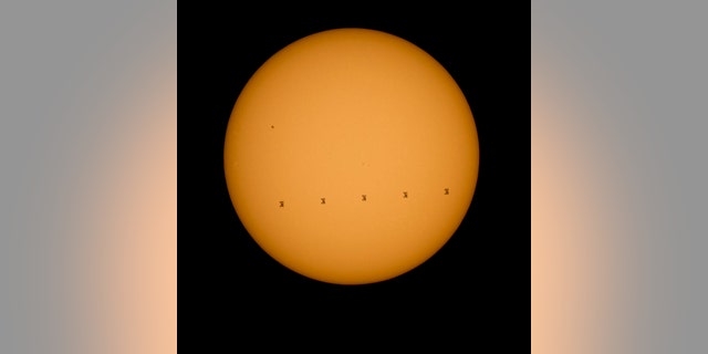 This composite photo made from five images shows the International Space Station crossing the sun’s face on Sept. 6, 2015. The images were captured from Shenandoah National Park in Virginia.
