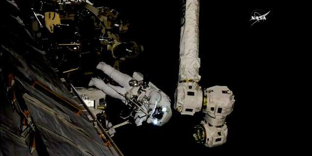 In this frame from NASA TV, Astronaut Mark Vande Hei works on the International Space Station on Thursday, Oct. 5, 2017. Hei and Randy Bresnik went out on a spacewalk to give the International Space Station's big robot arm a new hand.