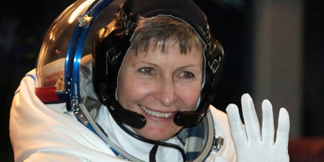 U.S. astronaut Peggy Whitson, member of the main crew of the expedition to the International Space Station, waves from a bus prior to the launch of Soyuz MS-3 spaceship.
