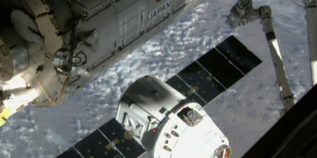 SpaceX’s uncrewed Dragon cargo ship approaches the International Space Station (ISS) on April 17, 2015, in this still from a camera on the orbiting lab’s exterior. This same Dragon arrived at the space station on Dec. 17, 2017.