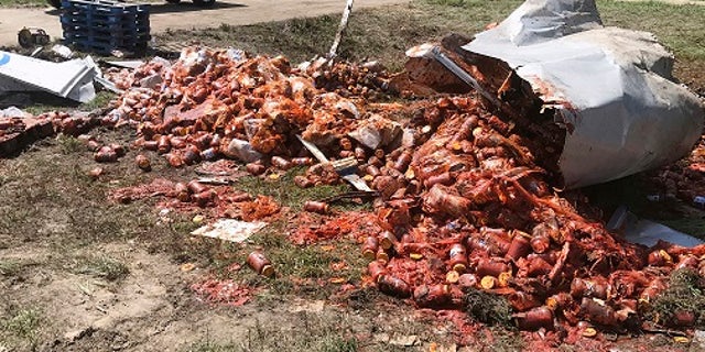 Broken jars of spaghetti sauce littered a road near Camden, Ark. on Aug. 21.