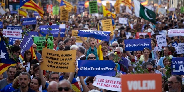 People participate in a demonstration condemning last week's attacks that killed 15 people in Spain.