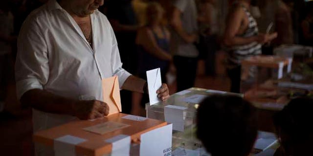 A man casts his vote for the national elections in Barcelona, Spain, Sunday. Spaniards voted Sunday in an unprecedented repeat election that aimed to break six months of political deadlock after a December ballot left the country without an elected government. (AP Photo/Emilio Morenatti)