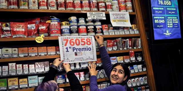 Dec. 22, 2012: Laura Leon, 30, right, and Pili Medina, 48, who sold one of the winning lottery tickets with the numbers, 76058, of the top prize of Spain's Christmas lottery known as "El Gordo," celebrates in her lottery shop in the small town of Tudela, northern Spain.