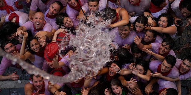 JULY 6: Water is thrown on to revelers during the launch of the ‘Chupinazo’ rocket to celebrate the official opening of the 2016 San Fermin Fiestas.