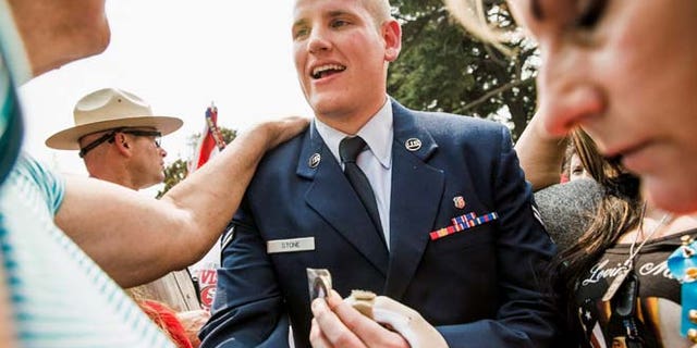 FILE 2015: Spencer Stone, who helped thwart an attack on a French train last August, greets fans in Sacramento. He is in stable condition after being stabbed four times in the chest.