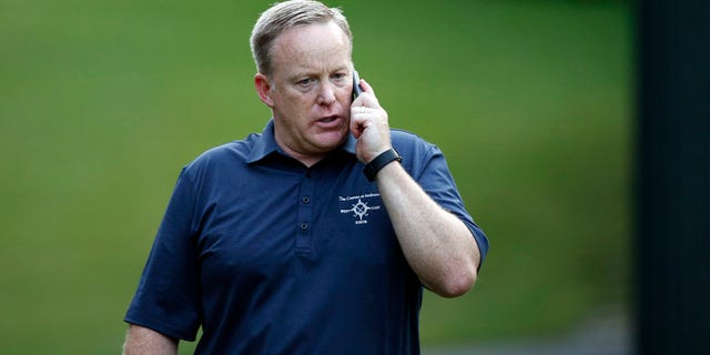White House Press Secretary Sean Spicer talks on a phone during the Congressional Picnic on the South Lawn of the White House, Thursday, June 22, 2017, in Washington. (AP Photo/Alex Brandon)
