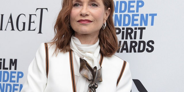 Isabelle Huppert poses with her award for best female lead for "Elle"