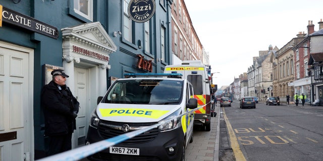 A policeman stands outside the Zizzi restaurant in Salisbury, England Wednesday, March 7, 2018 near to where former Russian double agent Sergei Skripal was found critically ill.